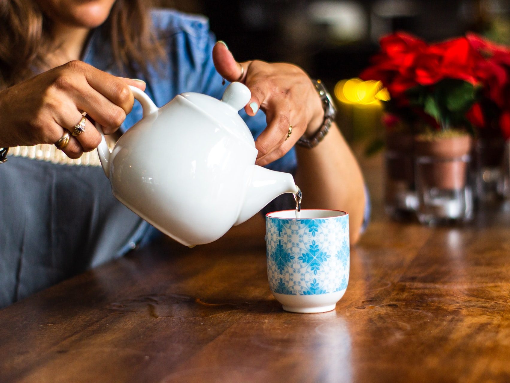 unknown person holding white ceramic kettle